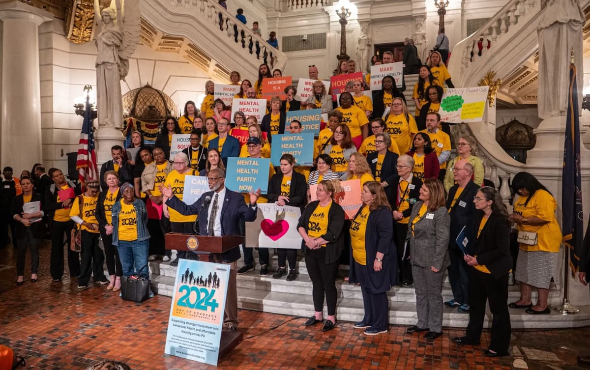 a group of people standing on stairs with signs