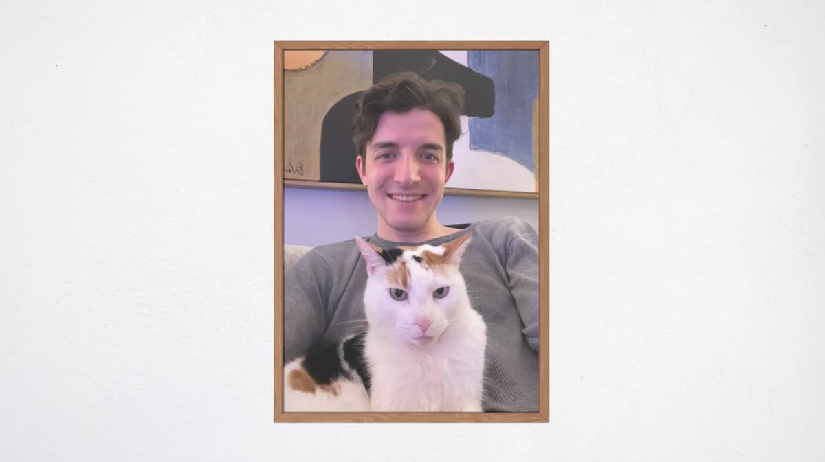 A framed picture of Michael Simonelli, smiling with his beloved cat Georgia.
