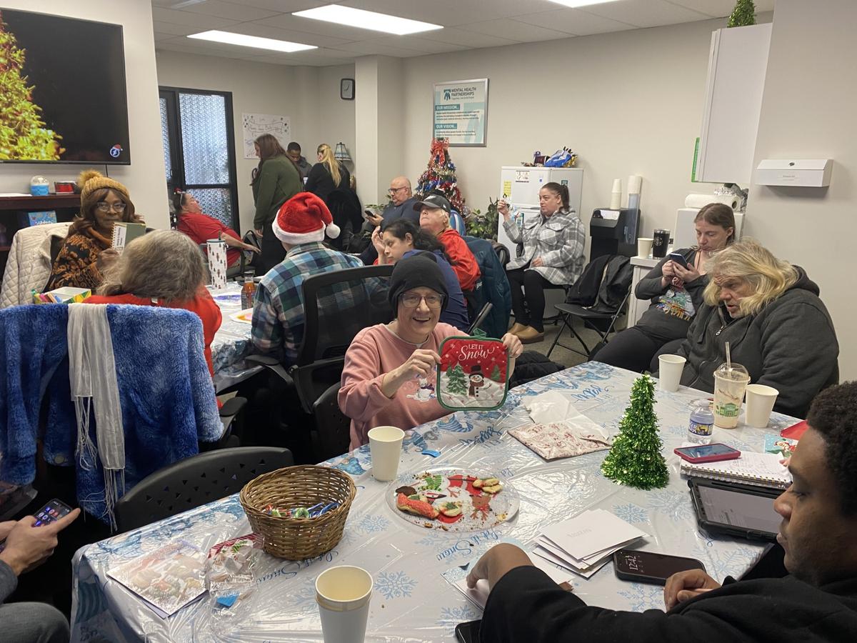 An image displaying a group of Mental Health Partnerships participants participating in a holiday celebration