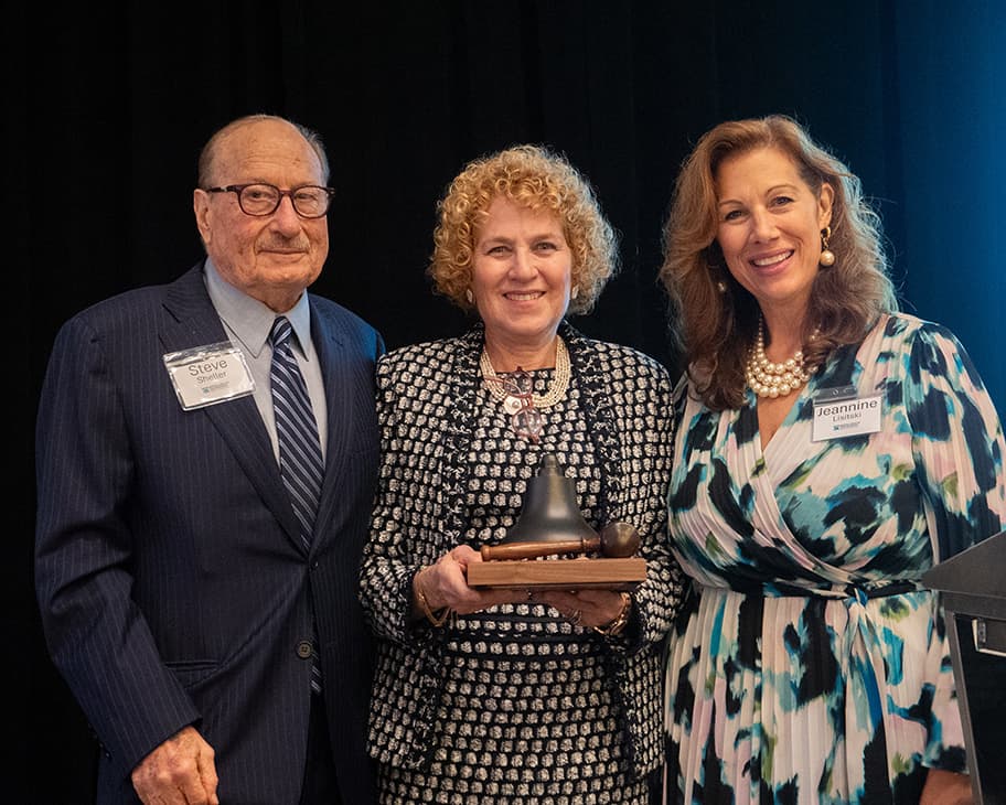 An image displaying our President & CEO, Dr. Jeannine L. Lisitski with the Bell of Hope recipient award